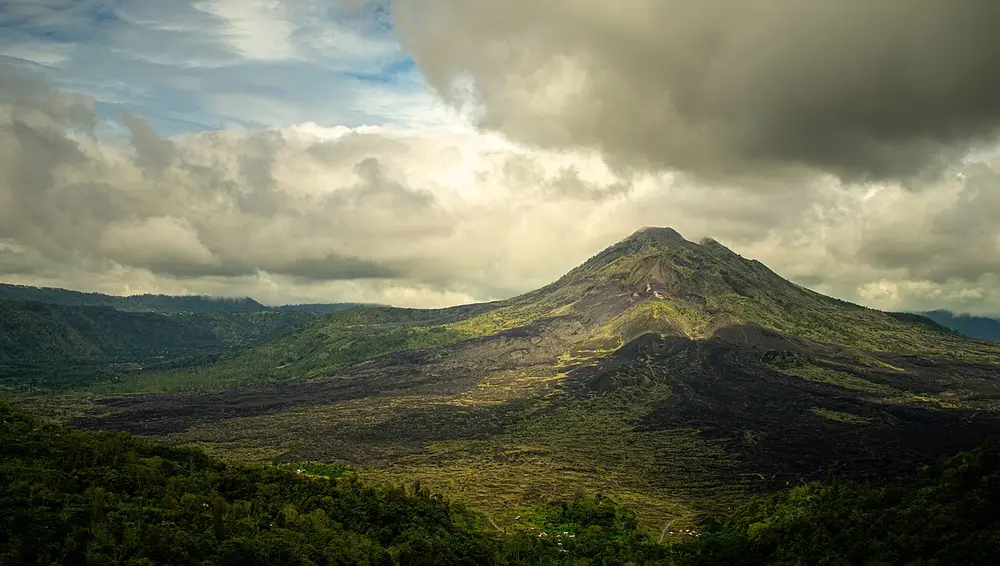 Mount Batur beneath dramatic clouds
